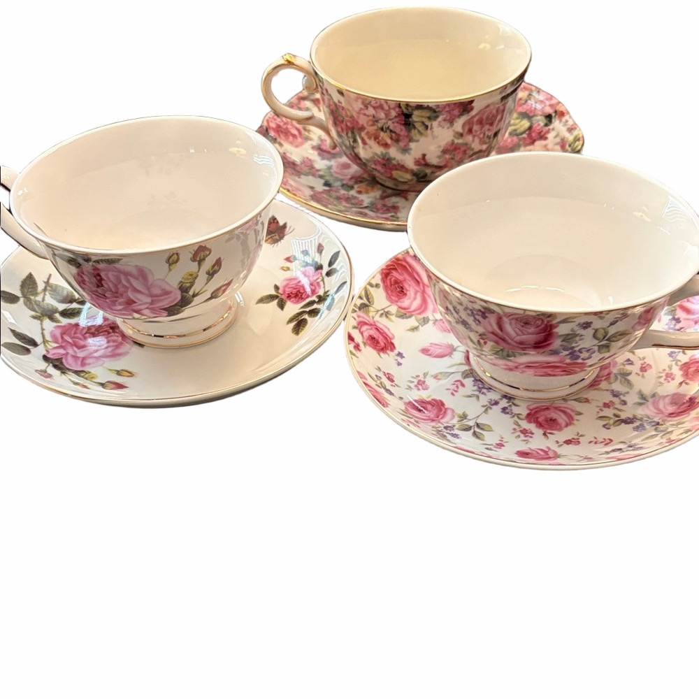 Three modern coordinating cup and saucer sets in shades of pink.